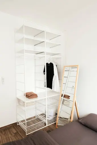 Custom wire wardrobe design for small bedrooms featuring adjustable hanging rails, open wire shelving, storage baskets, and a bottom shoe rack.